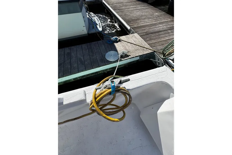 Slide: The Image of Coiled hose on 1982 Marine Trader Europa boat deck, docked at marina. - 17