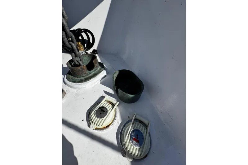 Slide: The Image of 1982 Marine Trader Europa boat helm with navigation equipment, docked in a marina. - 31