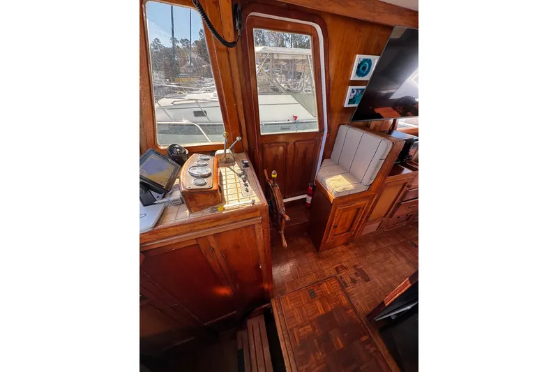 Slide: The Image of Interior of 1982 Marine Trader Europa boat with wooden cabinetry and modern amenities. - 39