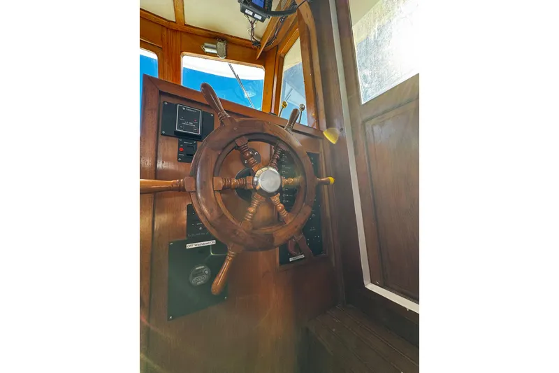 Slide: The Image of 1982 Marine Trader Europa interior with wooden helm, gauges, and seating. - 41