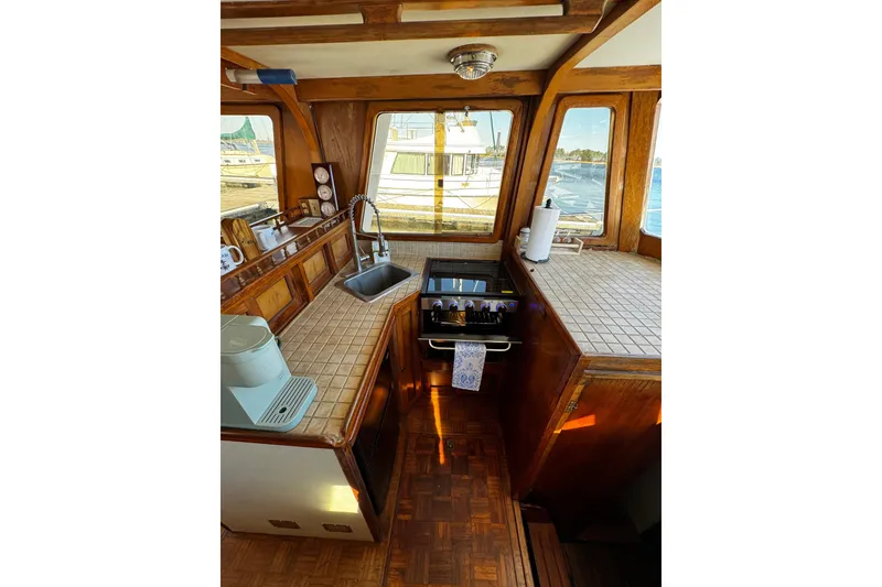 Slide: The Image of Open refrigerator on 1982 Marine Trader Europa boat, stocked with drinks and food items. - 65