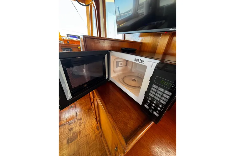Slide: The Image of 1982 Marine Trader Europa cabin interior with wooden finish and cozy bedding. - 70