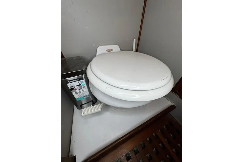 Slide: The Image of 1982 Marine Trader Europa cabin interior with wooden finish and dark bedding. - 72