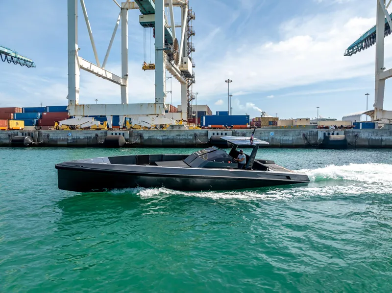 The Image of Wally 43 boat cruising in a port, 2012 model, with cranes and containers in the background. - 0