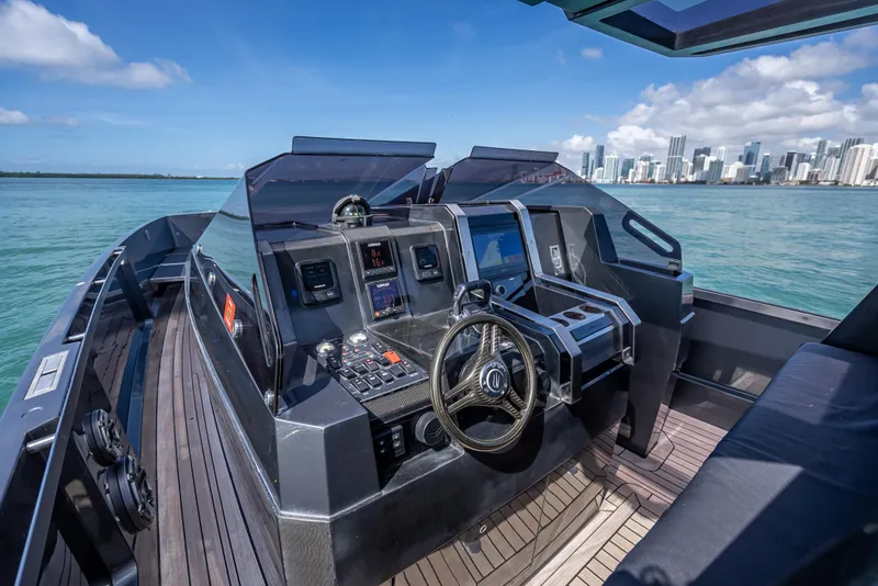 Slide: The Image of Luxurious 2012 Wally 43 yacht cockpit with modern controls, overlooking a city skyline. - 15
