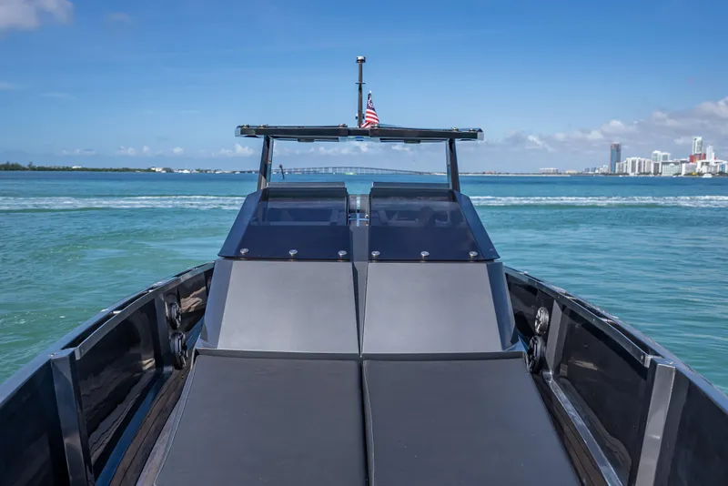 Slide: The Image of Luxury Wally 43 yacht cruising on clear blue waters, city skyline in background. - 20