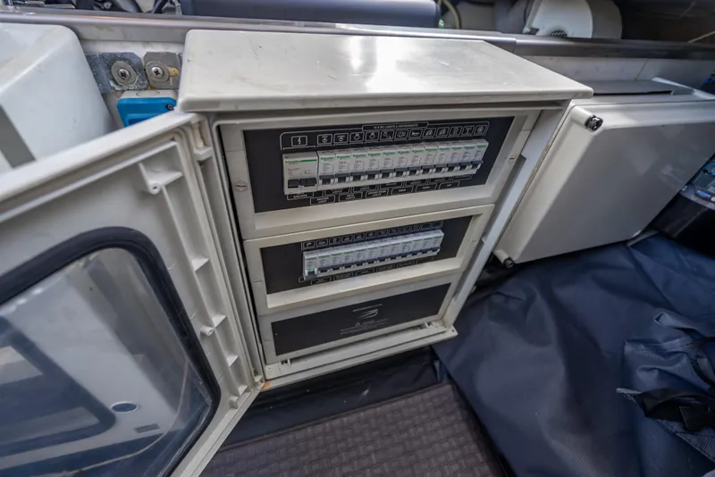 Slide: The Image of Electrical panel inside a 2012 Wally 43 boat, showing circuit breakers and wiring. - 26