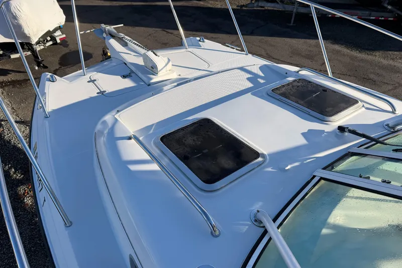 Slide: The Image of 2004 Glacier Bay 2670 Isle Runner boat deck with hatches and railing. - 13