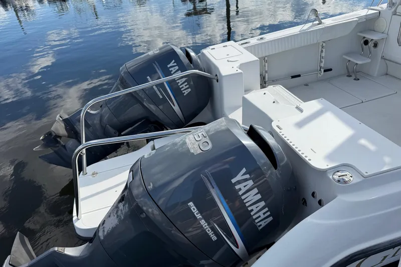 Slide: The Image of 2004 Glacier Bay 2670 Isle Runner boat docked, featuring spacious seating and sleek design. - 4