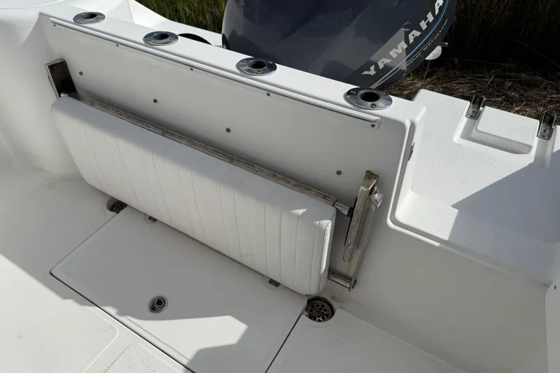 Slide: The Image of 2004 Glacier Bay 2670 Isle Runner boat deck with storage compartments and seating. - 5