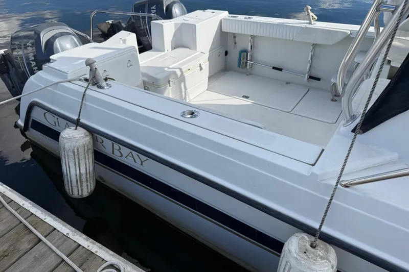 Slide: The Image of 2004 Glacier Bay 2670 Isle Runner boat docked with visible Yamaha engines. - 6