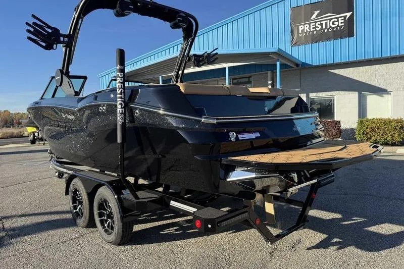 Slide: The Image of 2026 MasterCraft NXT23 boat interior with tan and black seating, showcasing luxury design. - 2