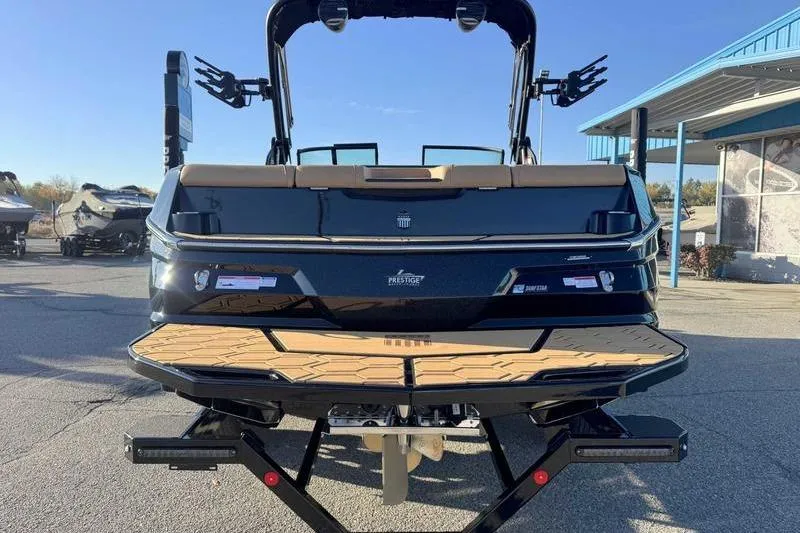 Slide: The Image of 2026 MasterCraft NXT23 boat on trailer at Prestige Water Sports dealership. - 3