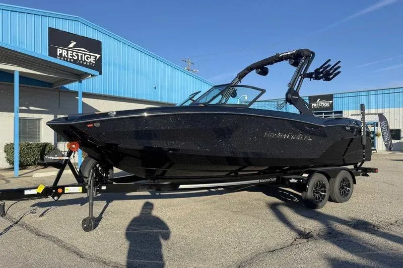 Slide: The Image of 2026 MasterCraft NXT23 boat rear view, showcasing sleek design and modern features. - 4