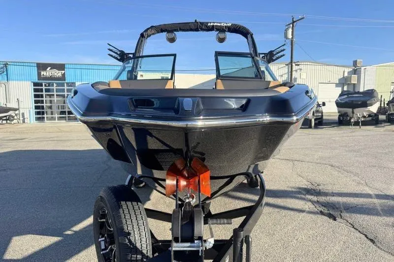 Slide: The Image of 2026 MasterCraft NXT23 boat on trailer at Prestige Water Sports dealership. - 5