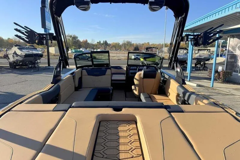 Slide: The Image of 2026 MasterCraft NXT23 boat on trailer at dealership, front view. - 6