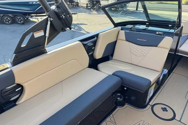 Slide: The Image of 2026 MasterCraft NXT23 boat dashboard with modern steering wheel and digital display. - 8