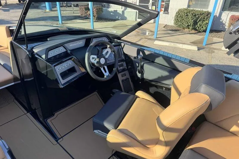 Slide: The Image of 2026 MasterCraft NXT23 boat interior with beige and black seating. - 9