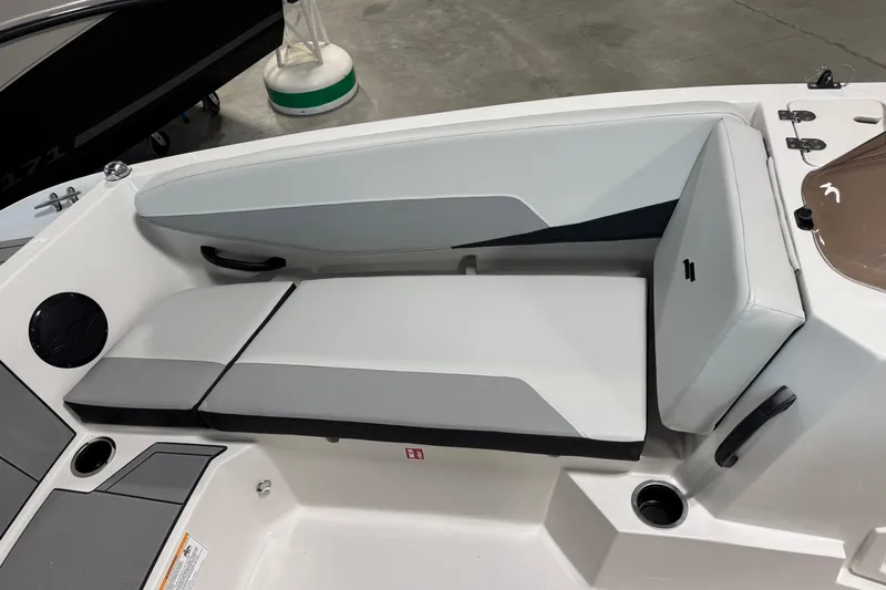 Slide: The Image of 2026 Starcraft SV 16 OB boat interior seating with gray cushions and cup holder. - 13