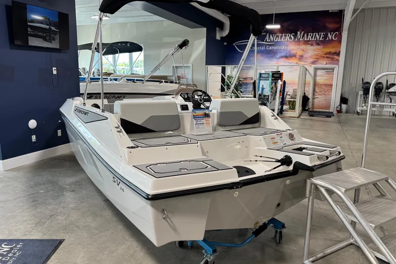 Slide: The Image of 2026 Starcraft SV 16 OB boat displayed indoors at Anglers Marine NC showroom. - 3