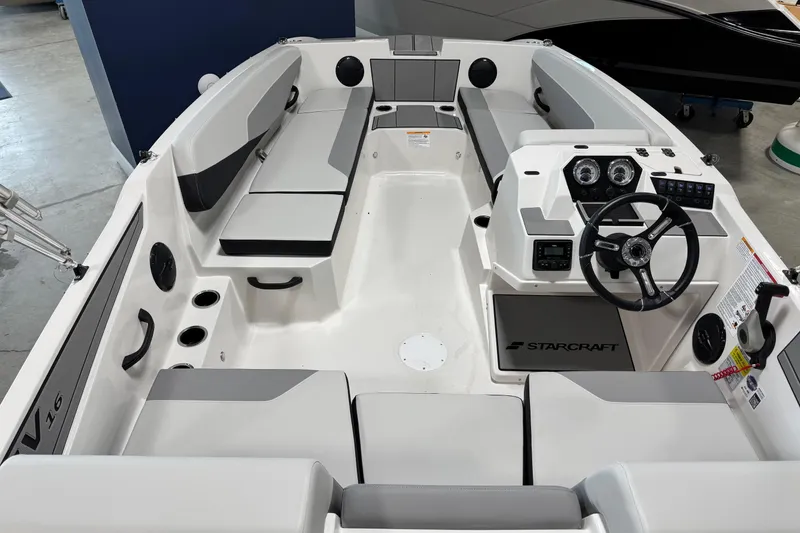 Slide: The Image of 2026 Starcraft SV 16 OB boat interior with seating and steering console. - 11