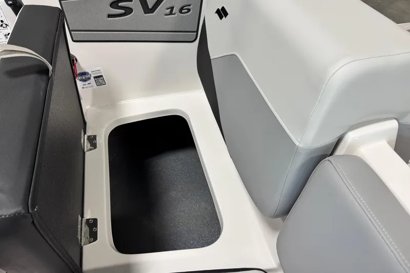 Slide: The Image of 2026 Starcraft SV 16 OB boat interior storage compartment with open lid. - 12