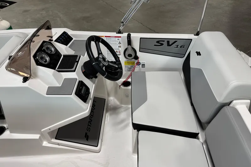 Slide: The Image of 2026 Starcraft SV 16 OB boat interior with steering wheel and seating. - 16