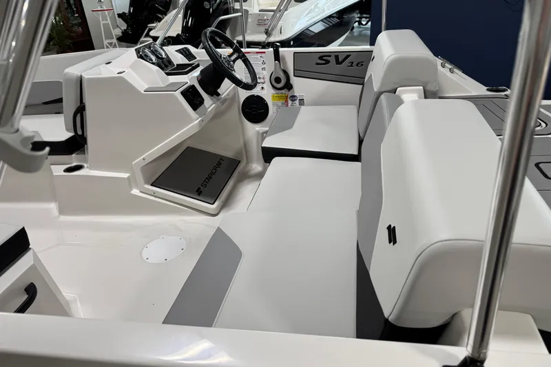 Slide: The Image of 2026 Starcraft SV 16 OB boat interior with modern seating and steering console. - 8