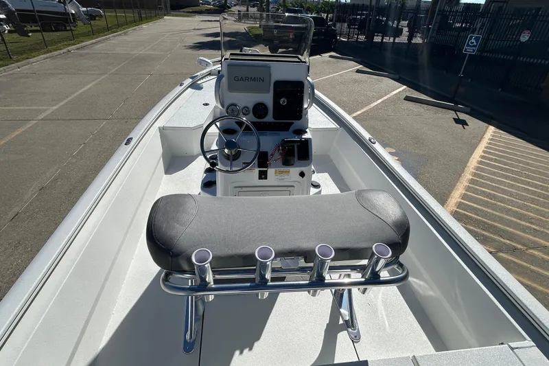 Slide: The Image of 2025 Avid 21 FST boat interior with Garmin navigation, steering wheel, and rod holders. - 10