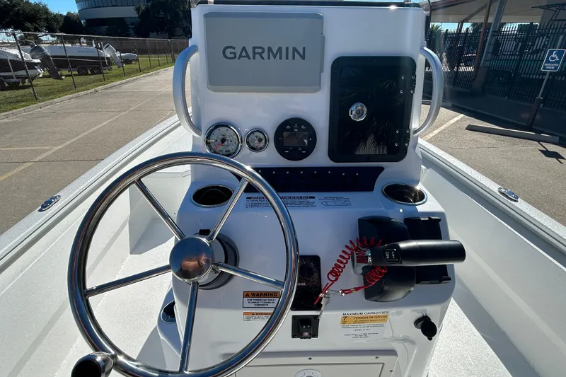 Slide: The Image of 2025 Avid 21 FST boat console with Garmin navigation and steering wheel. - 11