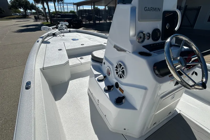 Slide: The Image of 2025 Avid 21 FST boat with Garmin navigation, sleek white design, and modern controls. - 12