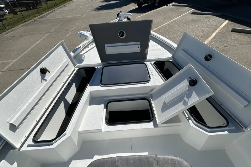 Slide: The Image of 2025 Avid 21 FST boat with open storage compartments on deck. - 16