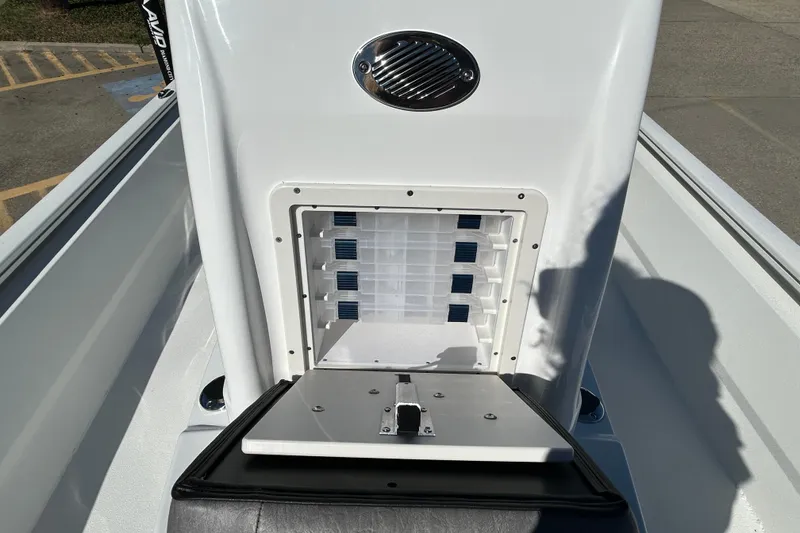 Slide: The Image of 2025 Avid 21 FST boat storage compartment with organized tackle boxes. - 19