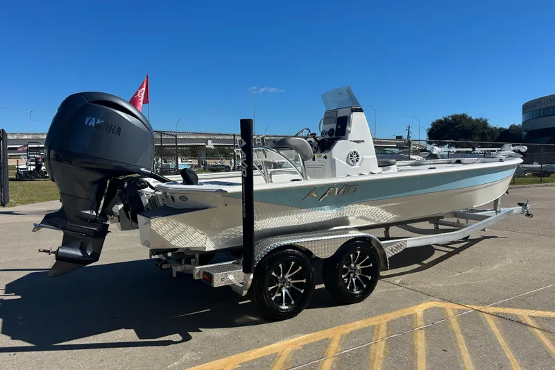 Slide: The Image of 2025 Avid 21 FST boat with Yamaha engine on a trailer, parked outdoors. - 3