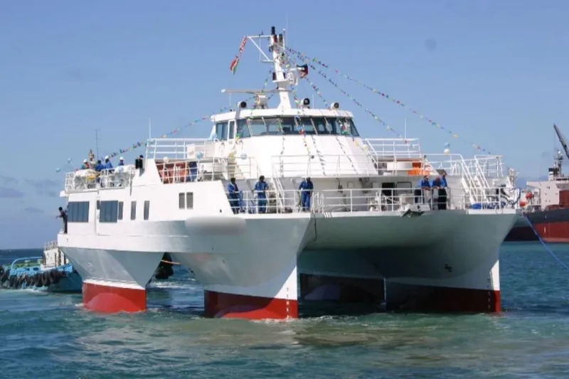 The Image of FBMA Philippines 2006 SWATH Slice Crew Transport Vessel on water, decorated with flags. - 1