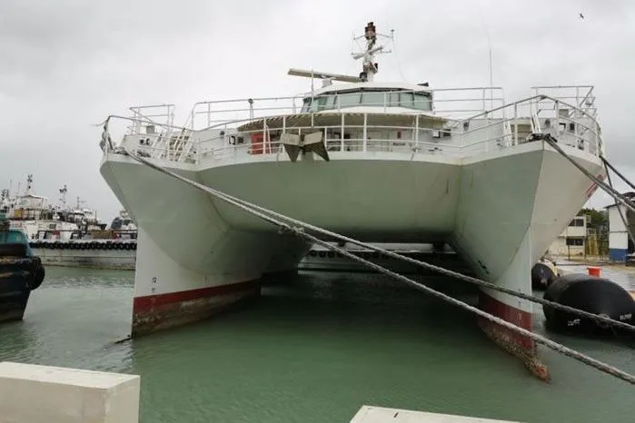 Slide: The Image of SWATH Slice Crew Transport Vessel by FBMA Philippines, 2006, docked in a harbor. - 3