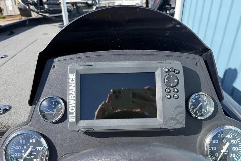 Slide: The Image of 2018 Ranger RT198P boat interior with dual red and gray seats, steering console, and storage. - 14