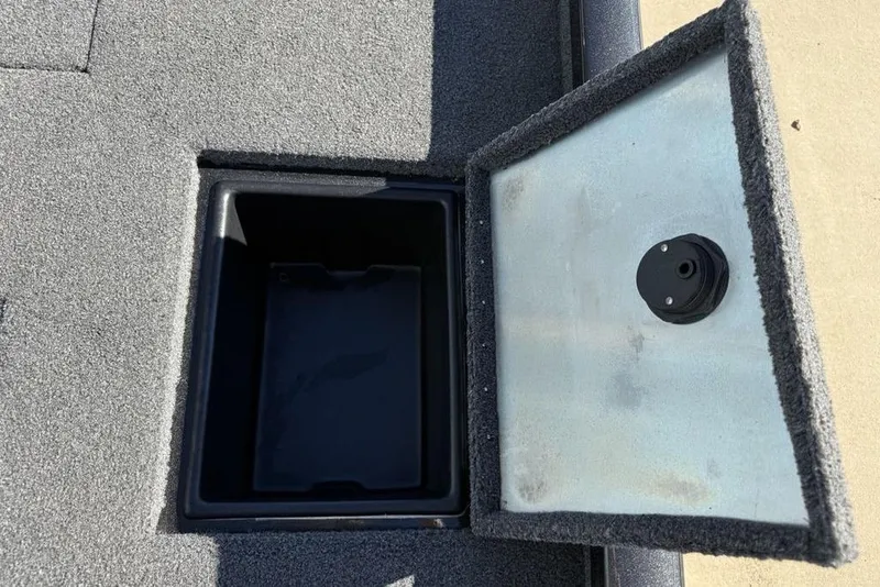 Slide: The Image of Open storage compartment on 2018 Ranger RT198P boat, featuring carpeted interior. - 25