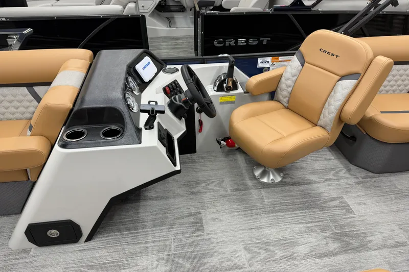 Slide: The Image of 2025 Crest Classic 220 boat interior with tan seating and modern dashboard controls. - 4