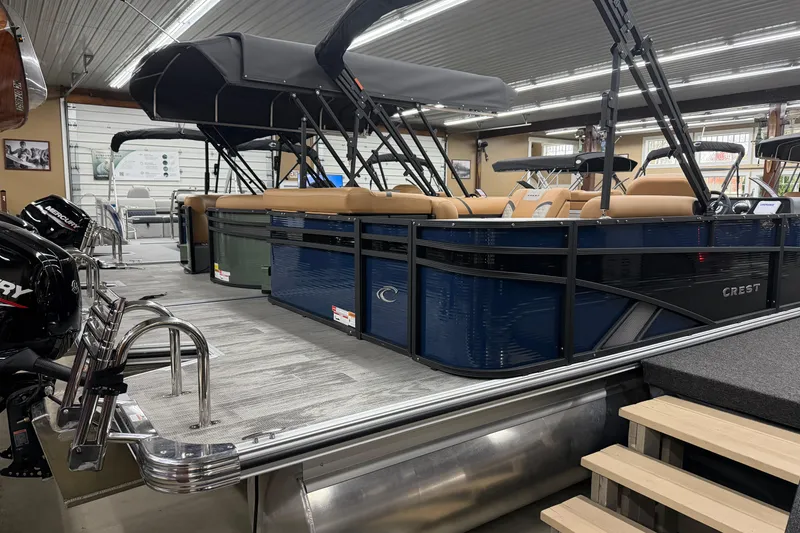 Slide: The Image of 2025 Crest Classic 220 pontoon boat in showroom, featuring sleek design and modern amenities. - 9