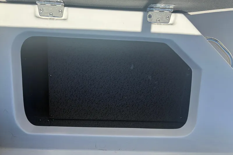 Slide: The Image of Storage compartment on a 2026 Starcraft SVX 171 OB boat, featuring a hinged lid. - 4