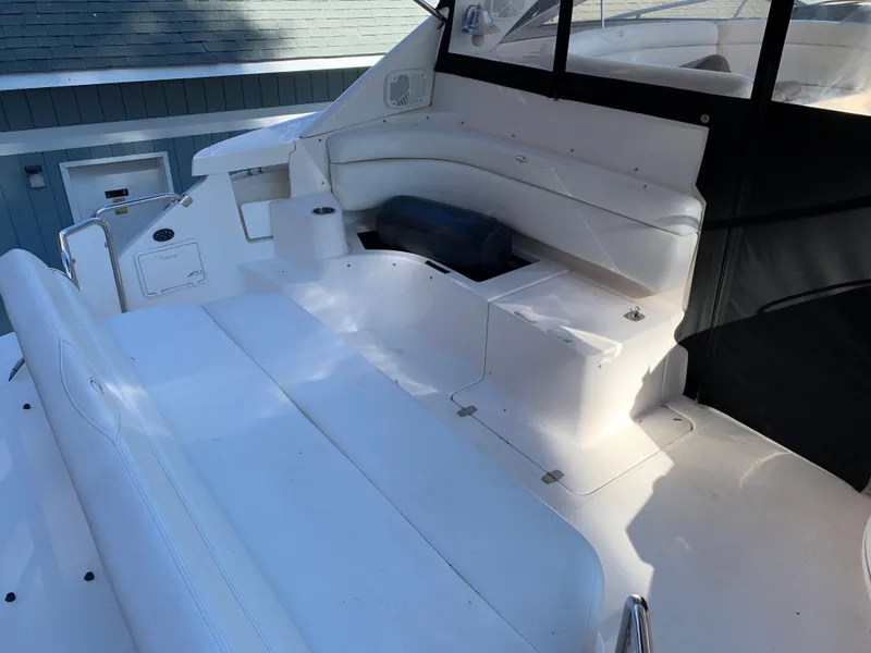 Slide: The Image of 2009 Regal 4460 yacht with white seating and storage compartments. - 13
