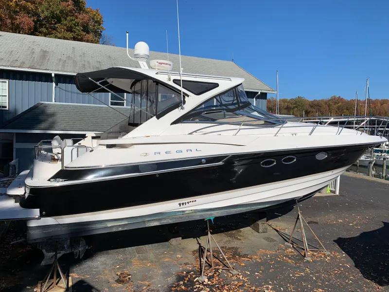 Slide: The Image of 2009 Regal 4460 yacht on stands at a marina. - 2