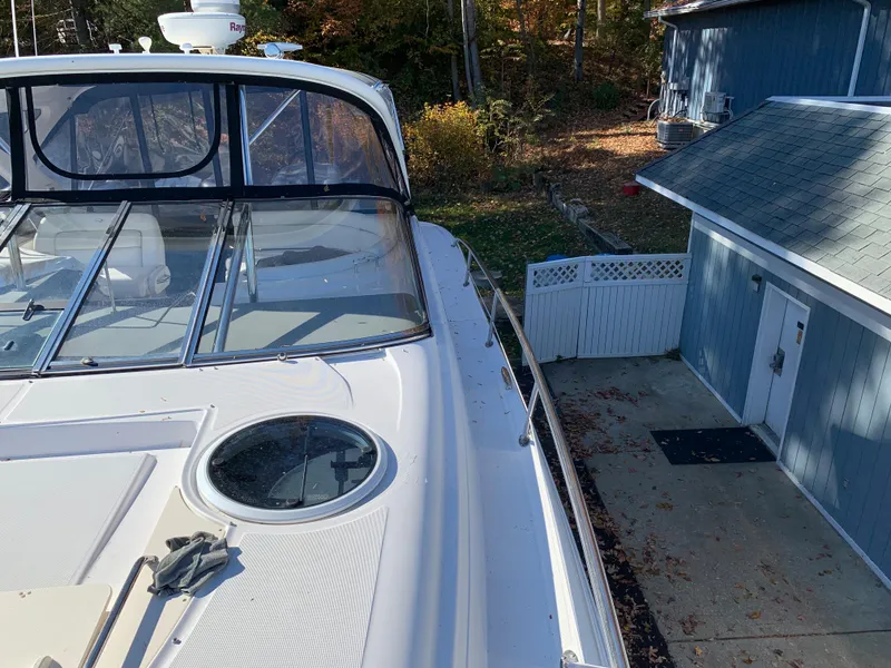 Slide: The Image of 2009 Regal 4460 yacht docked beside a blue boathouse. - 23