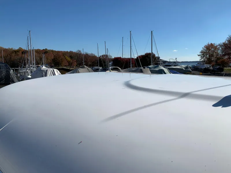 Slide: The Image of 2009 Regal 4460 boat docked with other vessels in a marina. - 25
