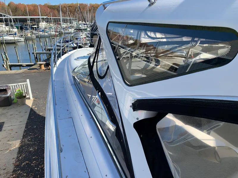 Slide: The Image of 2009 Regal 4460 yacht docked at a marina with other boats. - 26