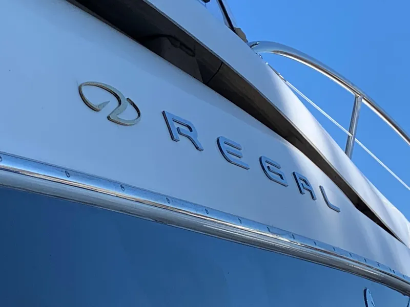 Slide: The Image of 2009 Regal 4460 yacht close-up with logo and railing. - 28
