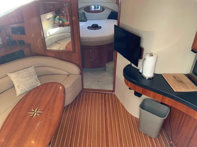 Slide: The Image of Interior of a 2009 Regal 4460 yacht with wood flooring and cozy seating area. - 31