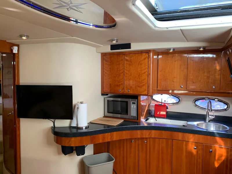 Slide: The Image of Interior of 2009 Regal 4460 yacht with modern kitchen and TV. - 33