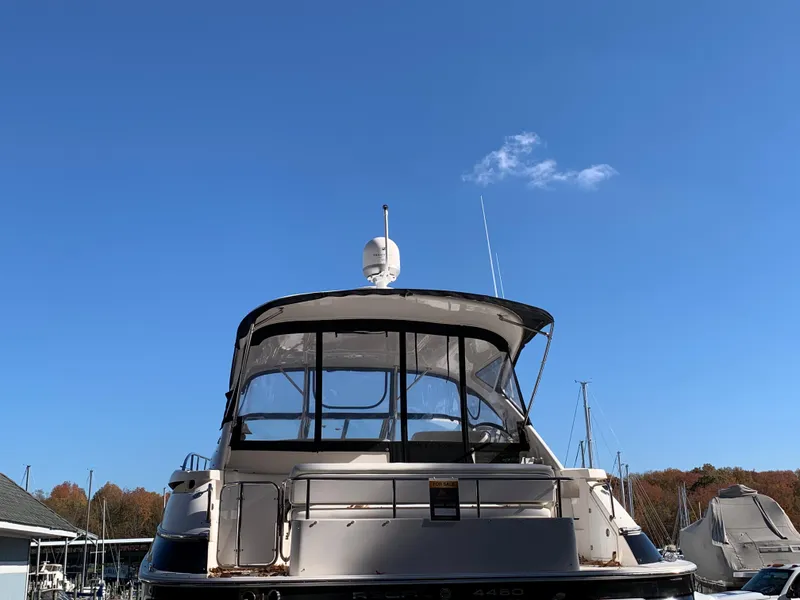 Slide: The Image of 2009 Regal 4460 yacht docked under clear blue sky. - 4